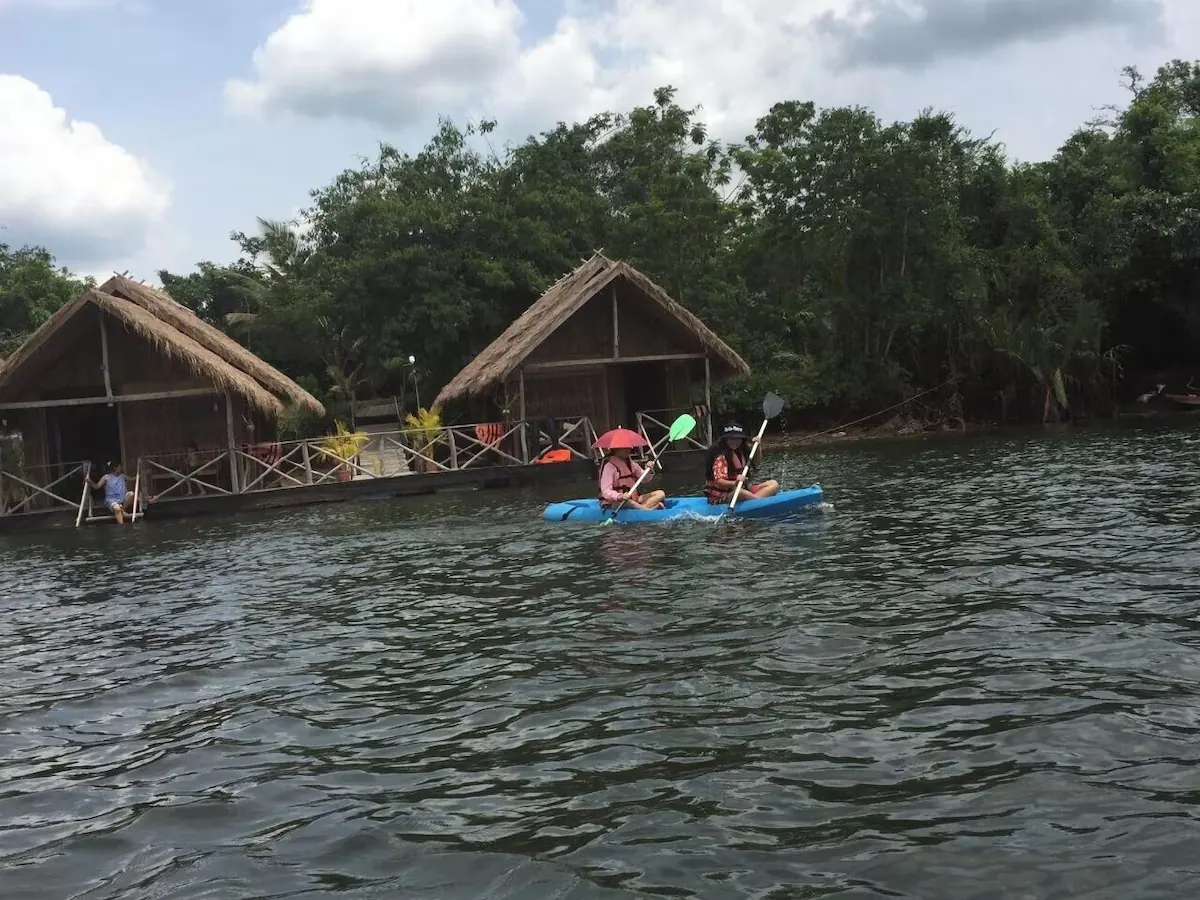 Kayaking beside bungalows